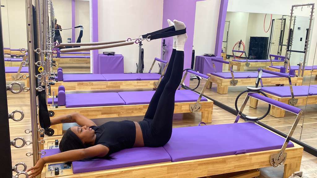 Woman on Reformer doing Pilates Exercise